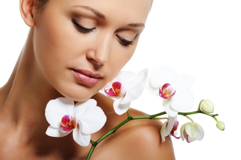 Fresh faced with orchids around the face to represent Facial services at BeauImage Salon and Spa